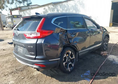 2019 Honda Cr-V Touring z USA, uszkodzony, nr VIN 7FARW2H90KE031598